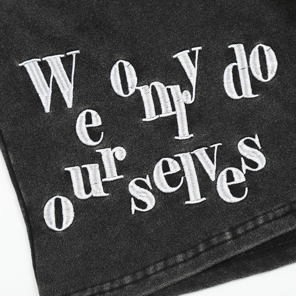 Stylish black shorts for men featuring unique embroidered text design