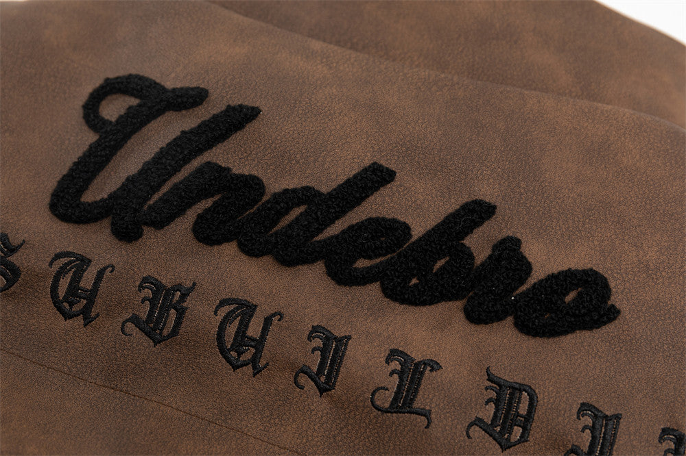 Close-up of a MONO//FIT cotton padded winter jacket showcasing its embroidered design detail