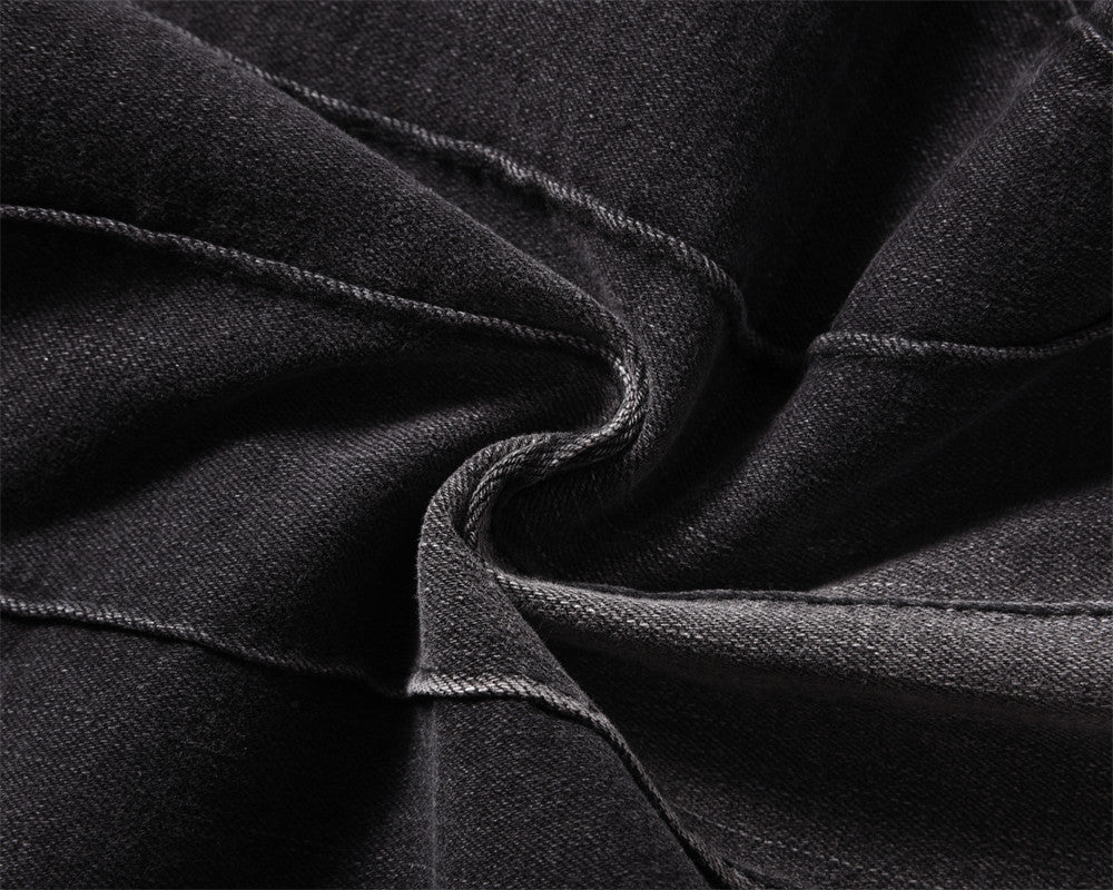 Close-up of MONO//FIT men's topstitching jeans with detailed stitching on black denim fabric