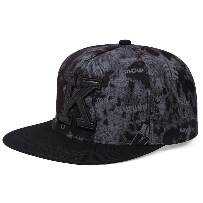 MONO//FIT K letter baseball cap in black with textured design and flat brim for a stylish look