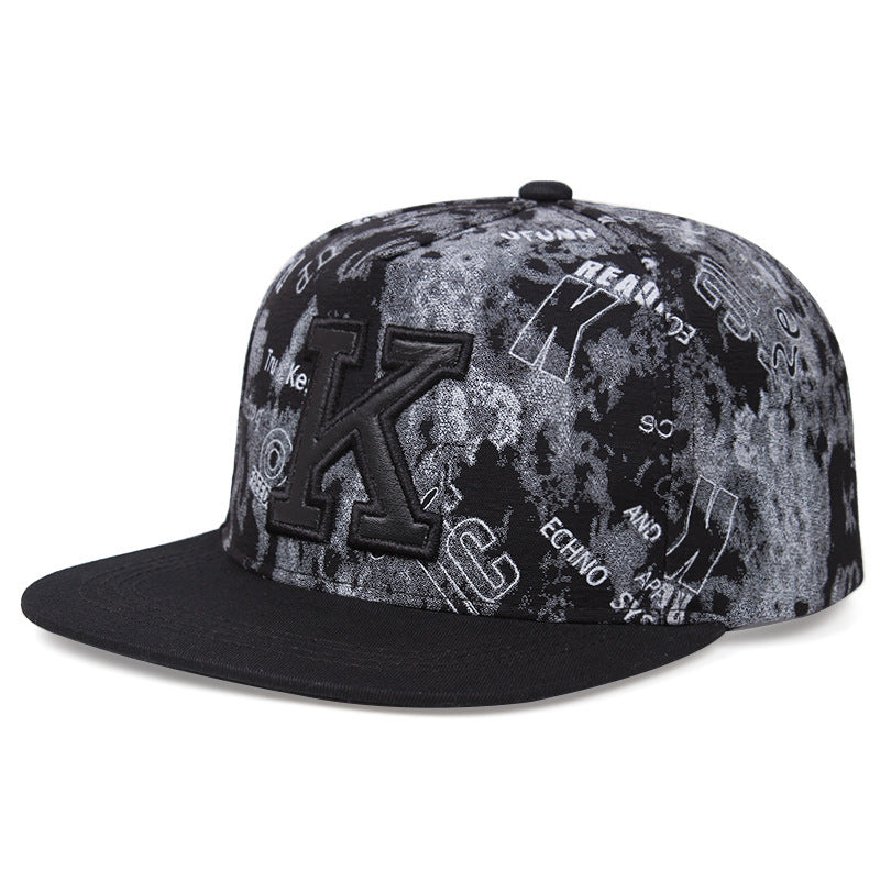 MONO//FIT K letter baseball cap featuring a black and gray patterned design