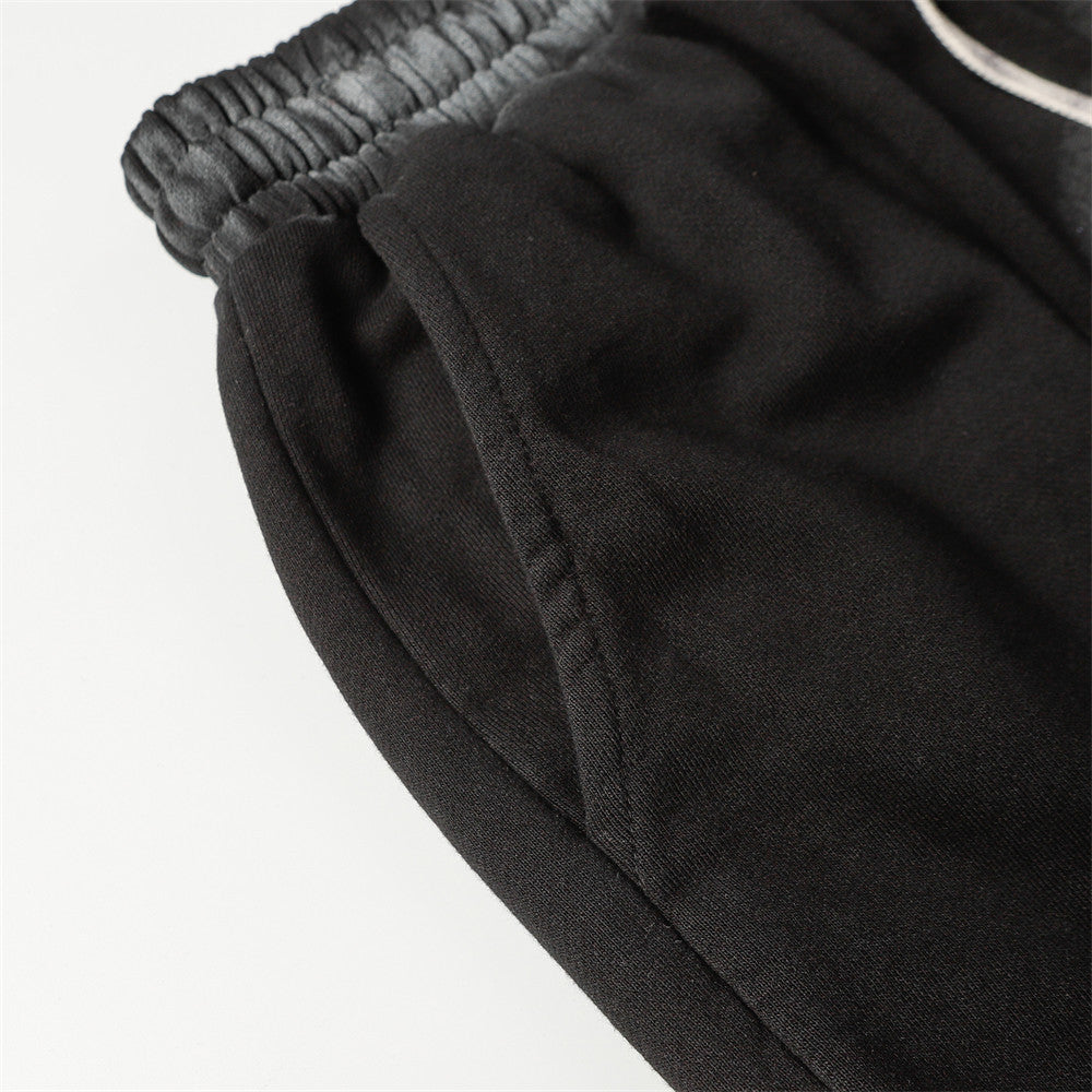 Close-up of MONO//FIT spray paint style shorts with elastic waistband for a comfortable fit