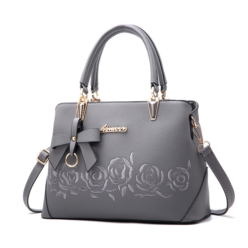 Stylish MONO//FIT fashionable women's handbag in gray with rose design and bow detail