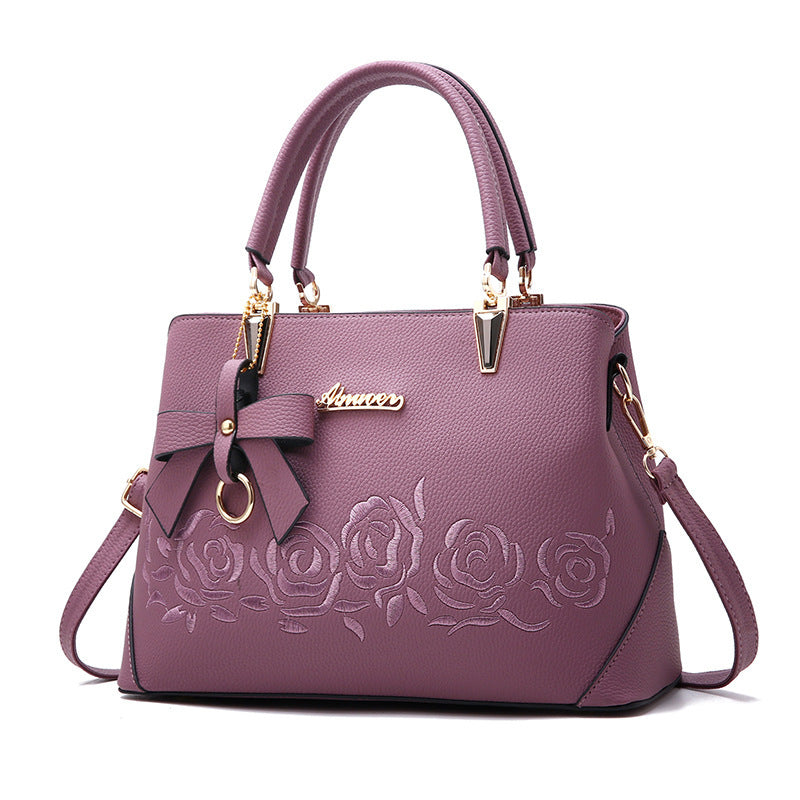 Stylish MONO//FIT fashionable women's handbag in purple with rose embroidery and bow detail