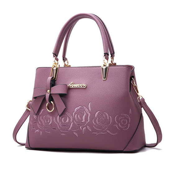 Stylish MONO//FIT fashionable women's handbag in purple with rose embroidery and bow detail