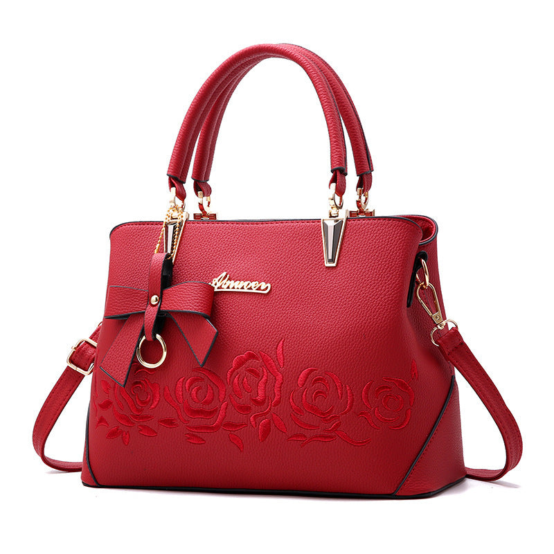 Stylish MONO//FIT fashionable women's handbag in red with floral embroidery and gold accents
