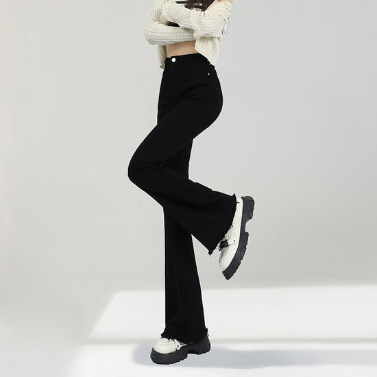 Stylish black weila jeans women with a flared cut, paired with a trendy top and casual footwear