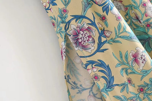 Close-up of floral print on MONO//FIT bohemian beach dresses with vibrant colors and design details