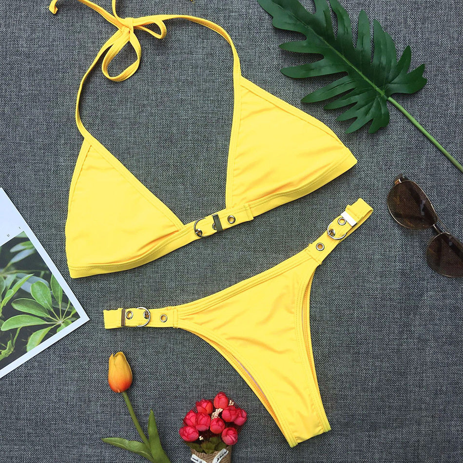 Bright yellow Brazilian bathing suit women featuring a triangle top and stylish bottom with decorative closures