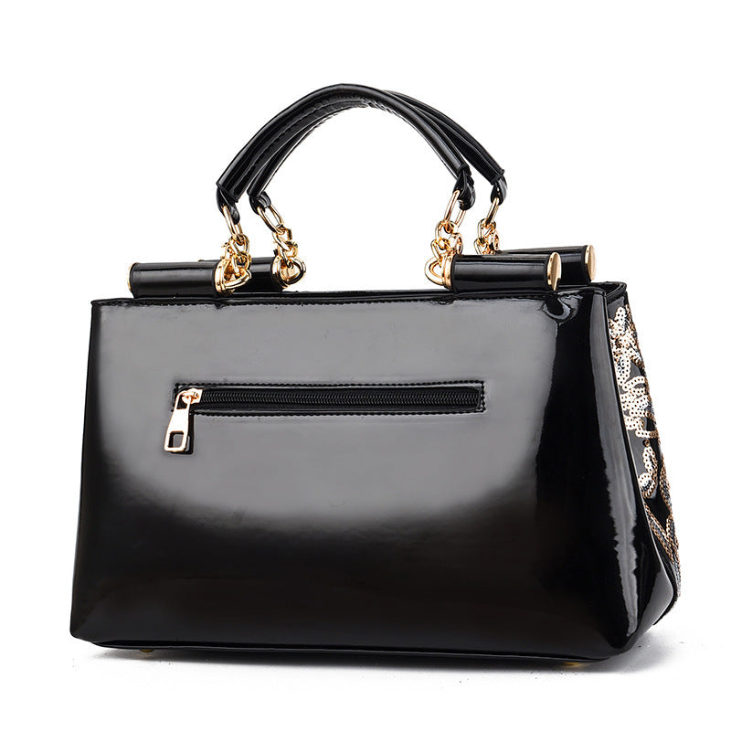 MONO//FIT elegant bridal party bag in glossy black with stylish gold accents and zipper closure