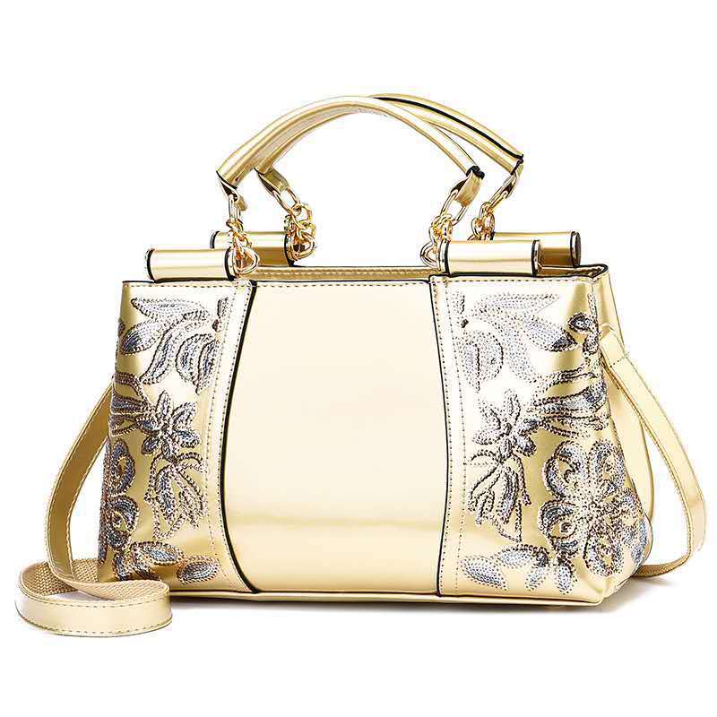 Elegant bridal party bag in gold with floral embellishments and dual handles for special occasions