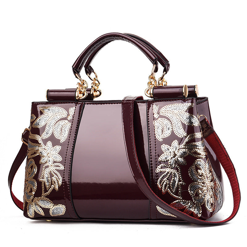 Elegant bridal party bag by MONO//FIT with glossy finish and ornate floral design