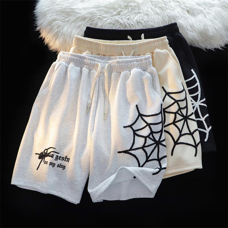 MONO//FIT embroidered spider shorts available in white, cream, and black designs with spider web details