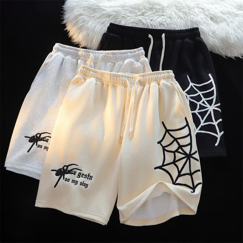 MONO//FIT embroidered spider shorts in three colors with unique spider web designs