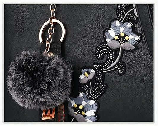 Close-up of MONO//FIT fashionable handbags for women with floral embroidery and a fluffy charm
