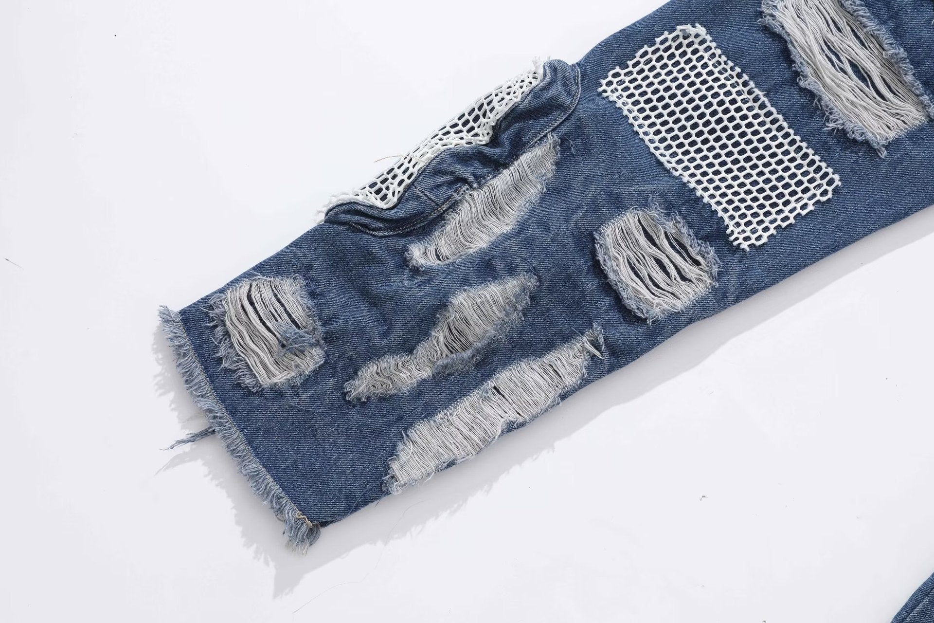 MONO//FIT heavy industry style jeans with distressed patches and mesh detailing for a rugged look