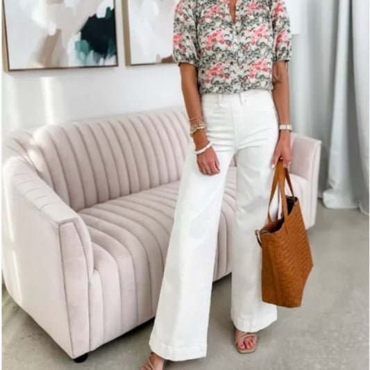 Fashionable MONO//FIT high waist wide leg jeans paired with a floral blouse and handbag