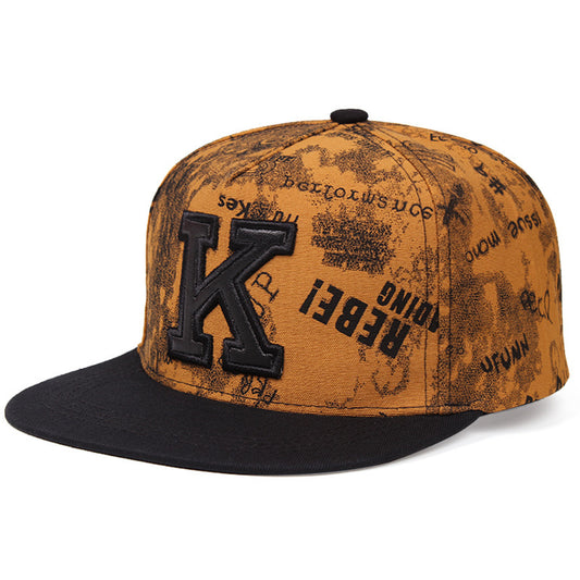 MONO//FIT K letter baseball cap in brown with a stylish graphic design and black brim