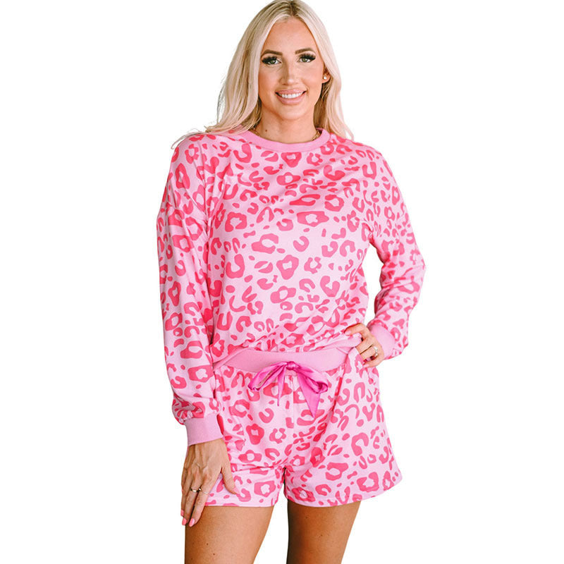 Stylish pink leopard print two-piece suit with a long sleeve top and shorts for comfortable lounging