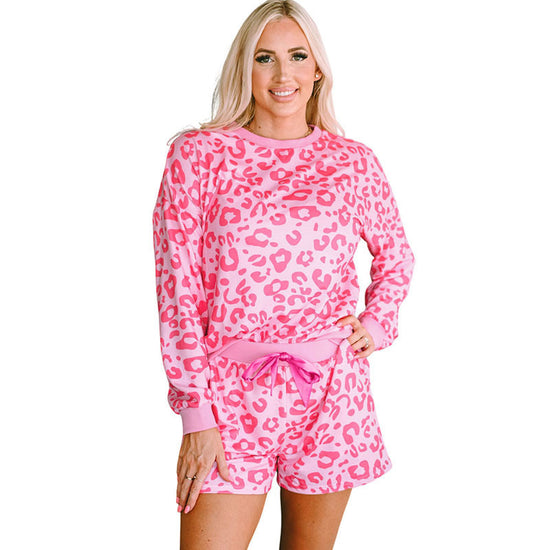 Stylish pink leopard print two-piece suit with a long sleeve top and shorts for comfortable lounging