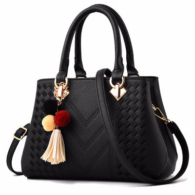 MONO//FIT luxury ladies handbags in black with stylish tassel and accessory details