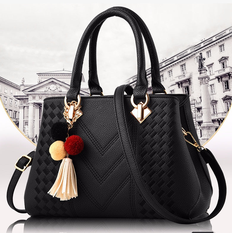 MONO//FIT luxury ladies handbags in black with decorative tassels and a chic design