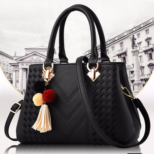 MONO//FIT luxury ladies handbags in black with decorative tassels and a chic design