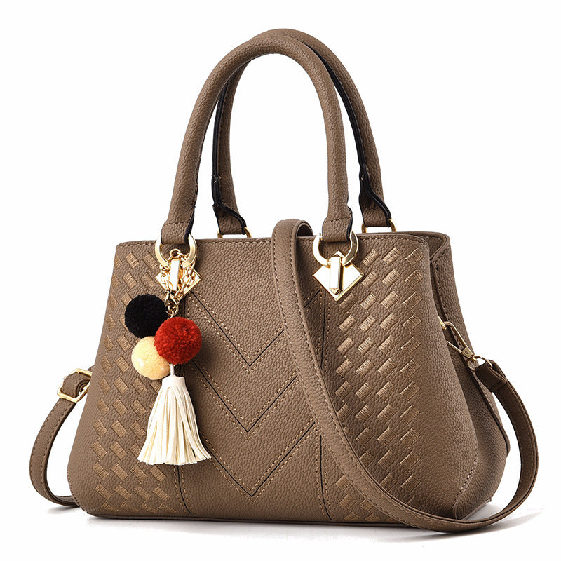 Stylish MONO//FIT luxury ladies handbags in brown with textured pattern and colorful tassel charm