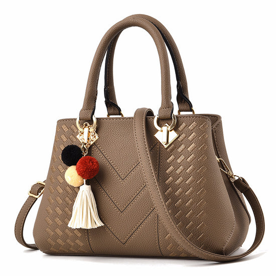 Stylish MONO//FIT luxury ladies handbags in brown with textured pattern and colorful tassel charm
