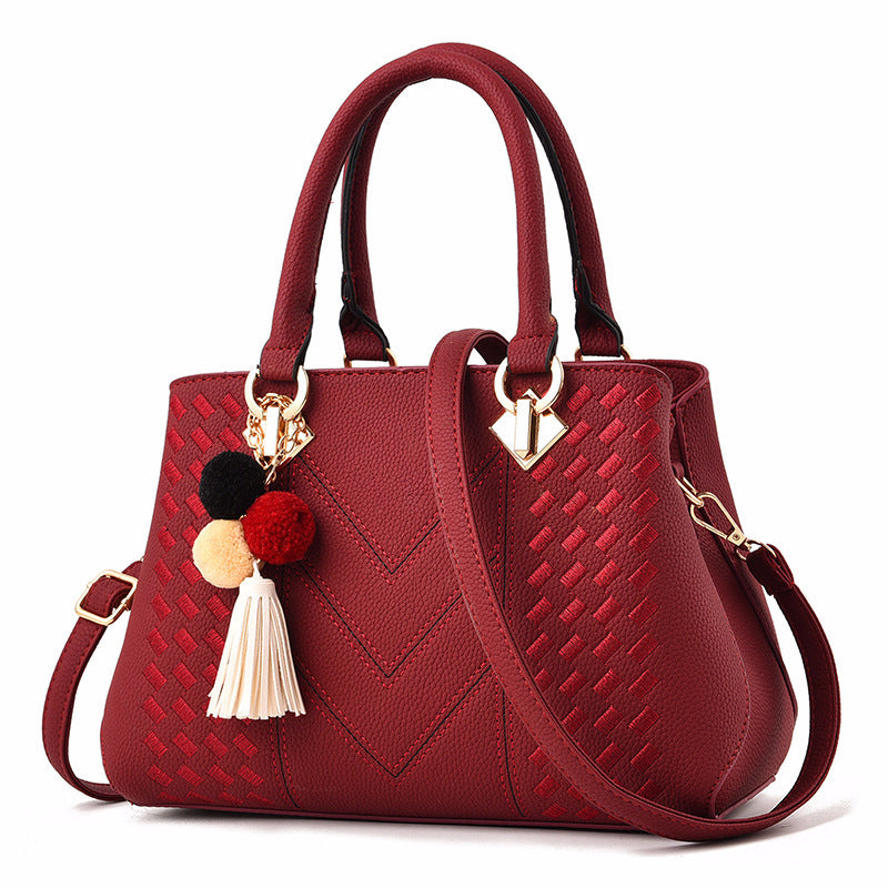 MONO//FIT luxury ladies handbags in red with braided design and colorful pom-poms