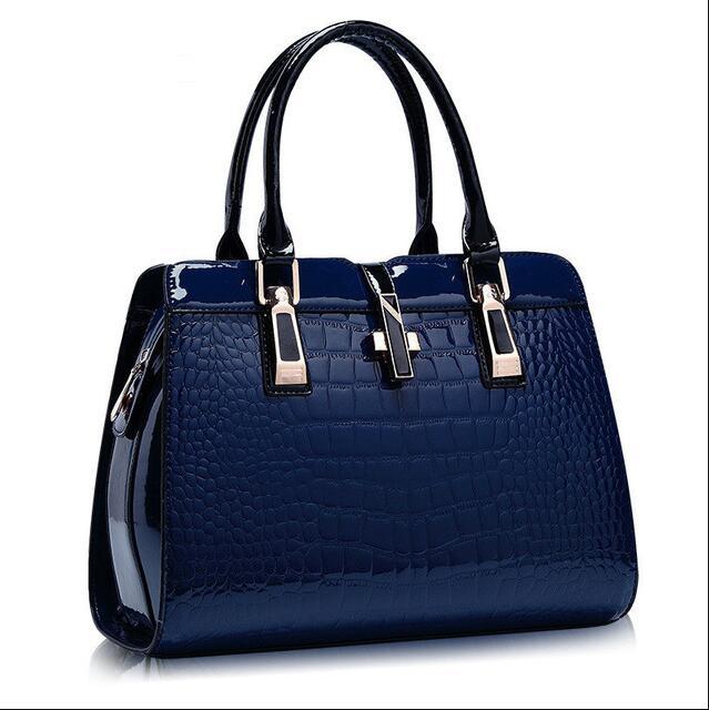MONO//FIT luxury women's handbags in navy blue with a stylish crocodile texture and sleek handles
