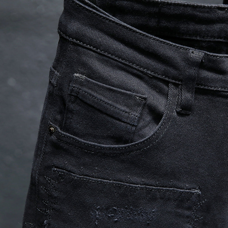 Close-up of MONO//FIT mens black ripped jeans highlighting the stitching and pockets