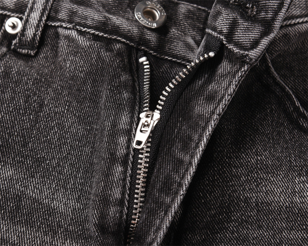 Close-up of MONO//FIT men's distressed wide-leg jeans showcasing zipper and fabric details