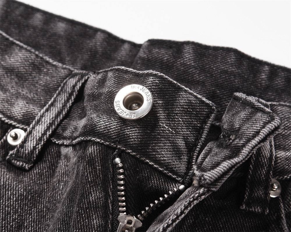 Close-up of MONO//FIT men's distressed wide-leg jeans with button and zipper detailing