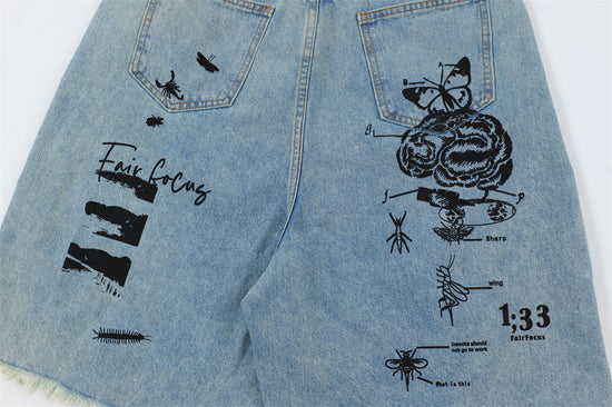 Men's printed denim shorts by MONO//FIT featuring unique graphic designs and a stylish look