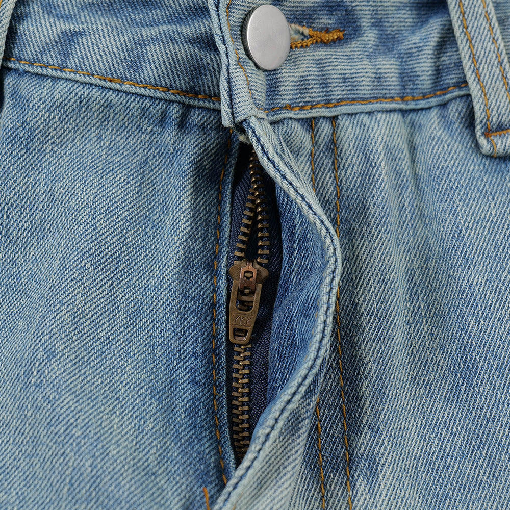 Close-up of MONO//FIT men's printed denim shorts featuring a zipper and button closure