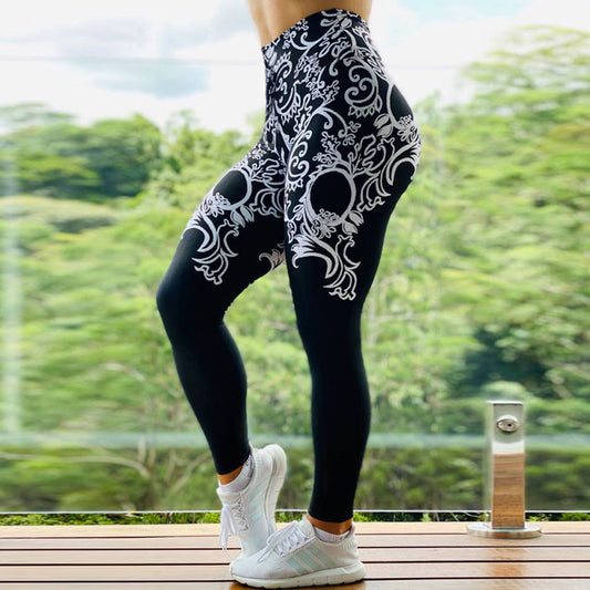 Women wearing printed sports leggings with intricate black and white design for workout and fitness activities