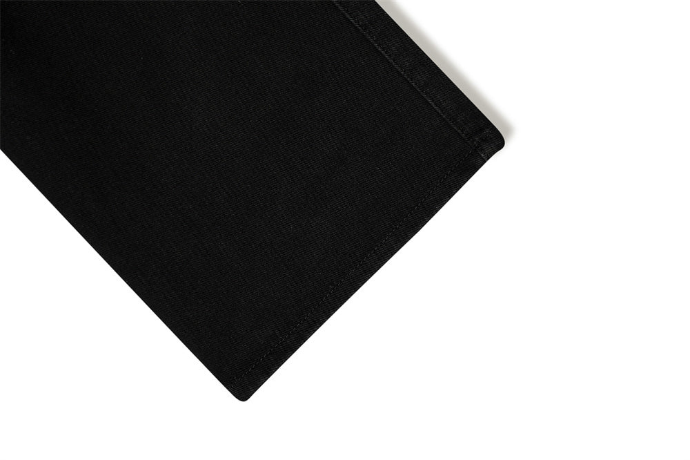 Close-up of MONO//FIT punk flared jeans men showcasing clean hemline and black fabric quality