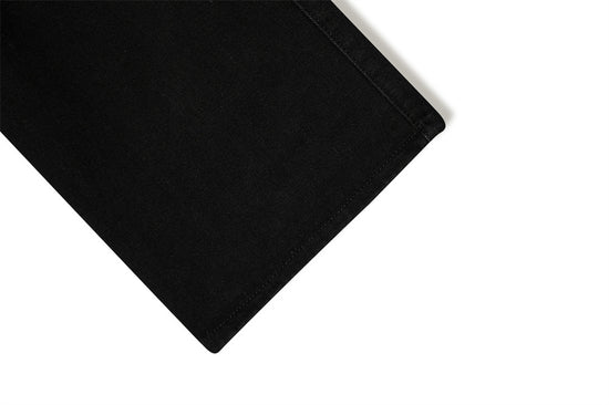 Close-up of MONO//FIT punk flared jeans men showcasing clean hemline and black fabric quality