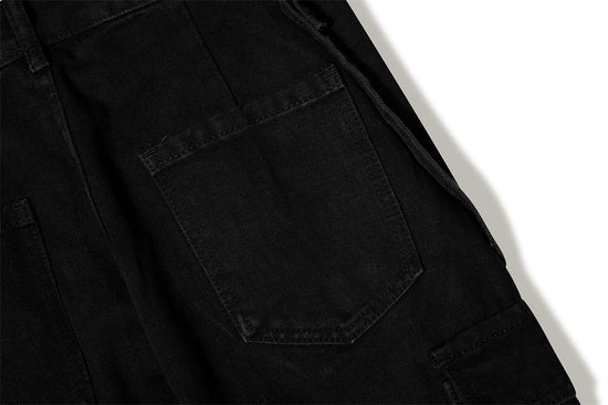 Close-up of MONO//FIT punk flared jeans men with black fabric and unique pocket design