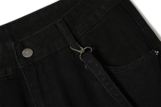 Close-up of MONO//FIT punk flared jeans men showcasing zipper detail and stylish black fabric