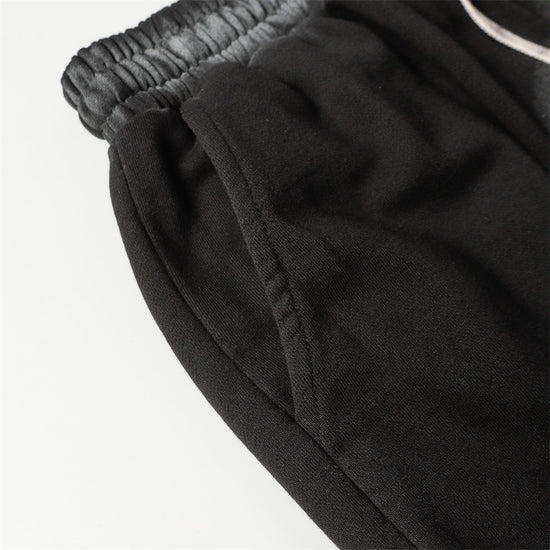Close-up of MONO//FIT spray paint style shorts with elastic waistband for a comfortable fit