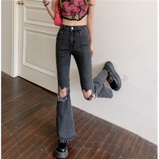 Trendy ripped jeans women in black with flared bottom and distressed details, perfect for casual outfits
