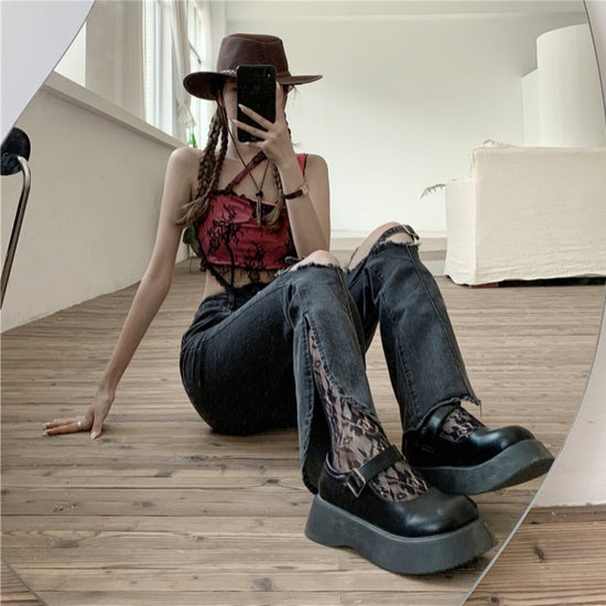 Woman wearing trendy ripped jeans women with a stylish top and hat in a cozy indoor setting