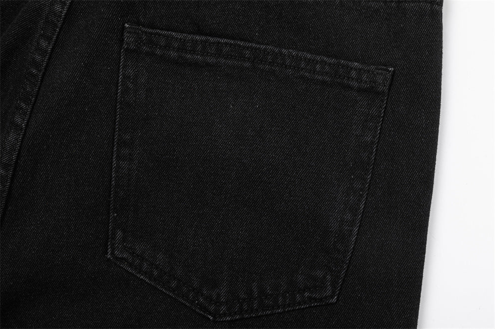 Close-up of MONO//FIT straight fit embroidered jeans back pocket detail in black denim