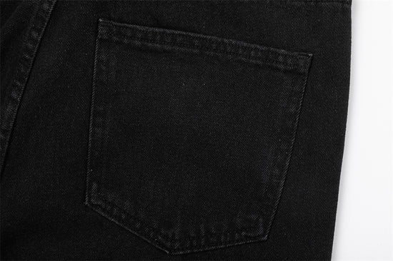 Close-up of MONO//FIT straight fit embroidered jeans back pocket detail in black denim