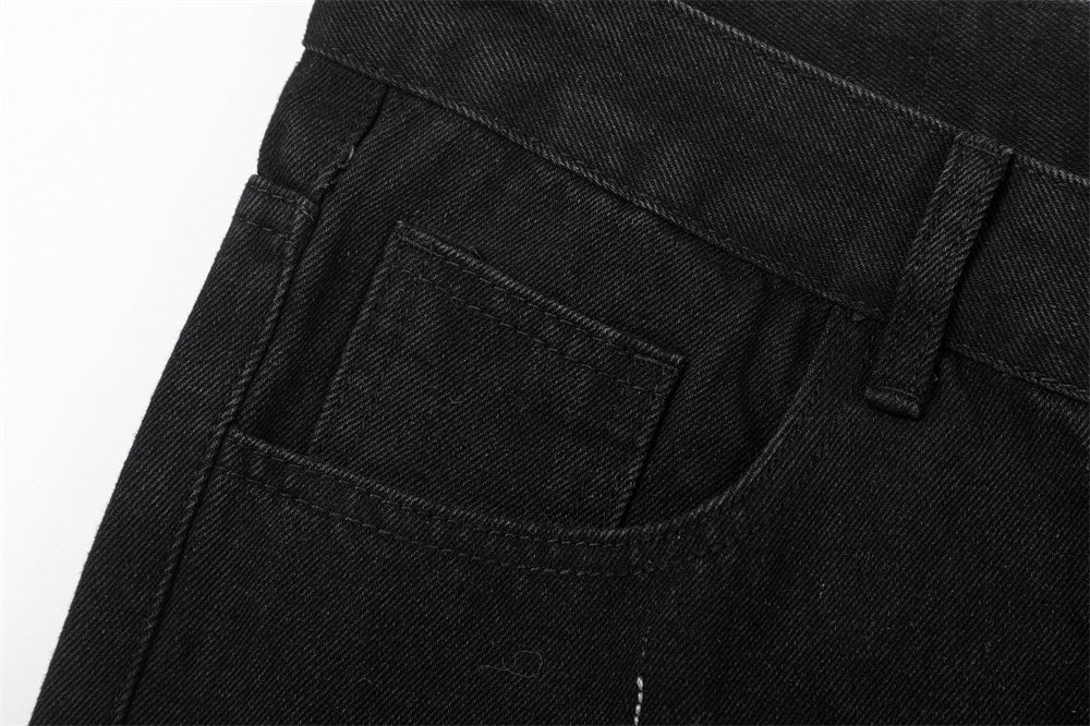Close-up of MONO//FIT straight fit embroidered jeans showing pocket detail and black denim fabric