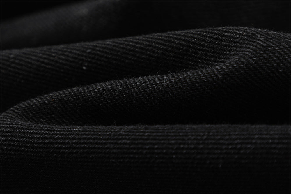 Close-up of MONO//FIT straight fit embroidered jeans showcasing textured black fabric