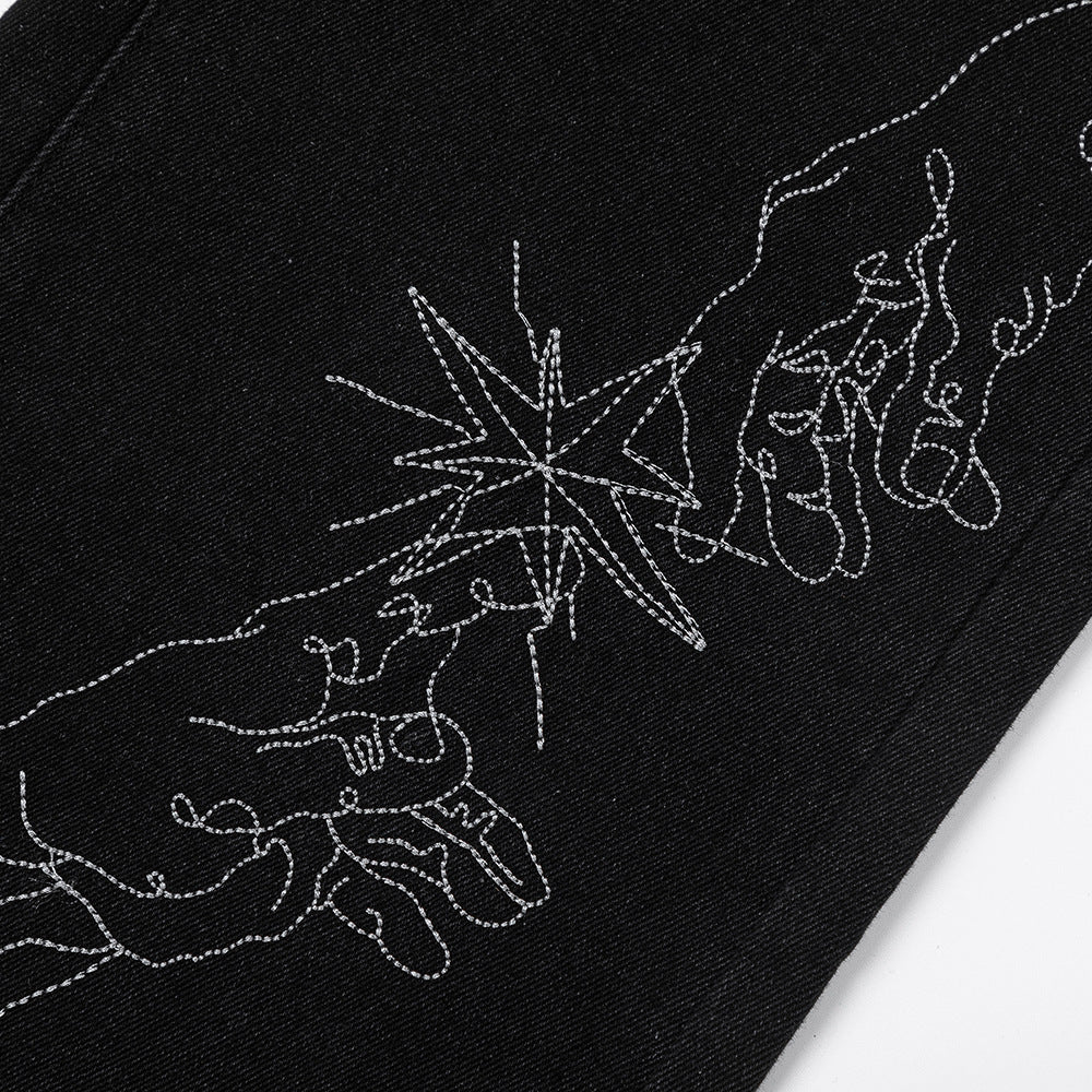 Close-up of MONO//FIT straight fit embroidered jeans featuring intricate hand design details