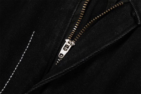 Close-up of MONO//FIT straight fit embroidered jeans with zipper detail for stylish men